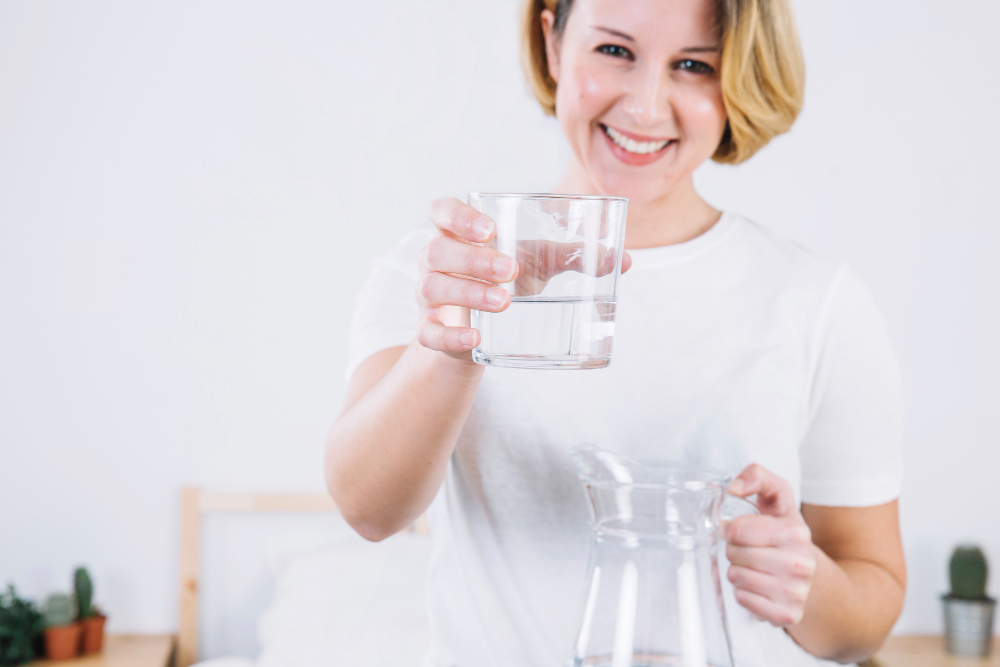 cheerful-woman-offering-water